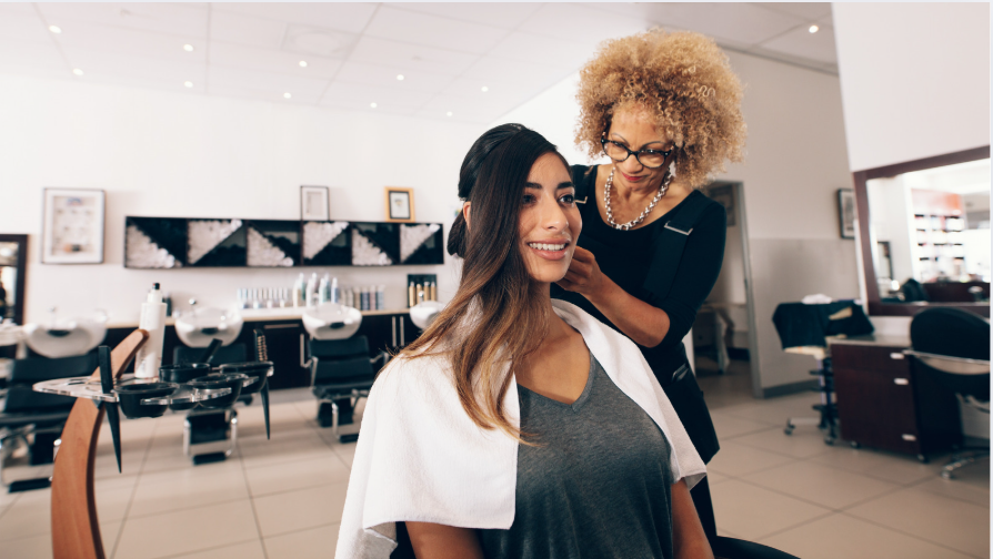 Hairstylist preparing client